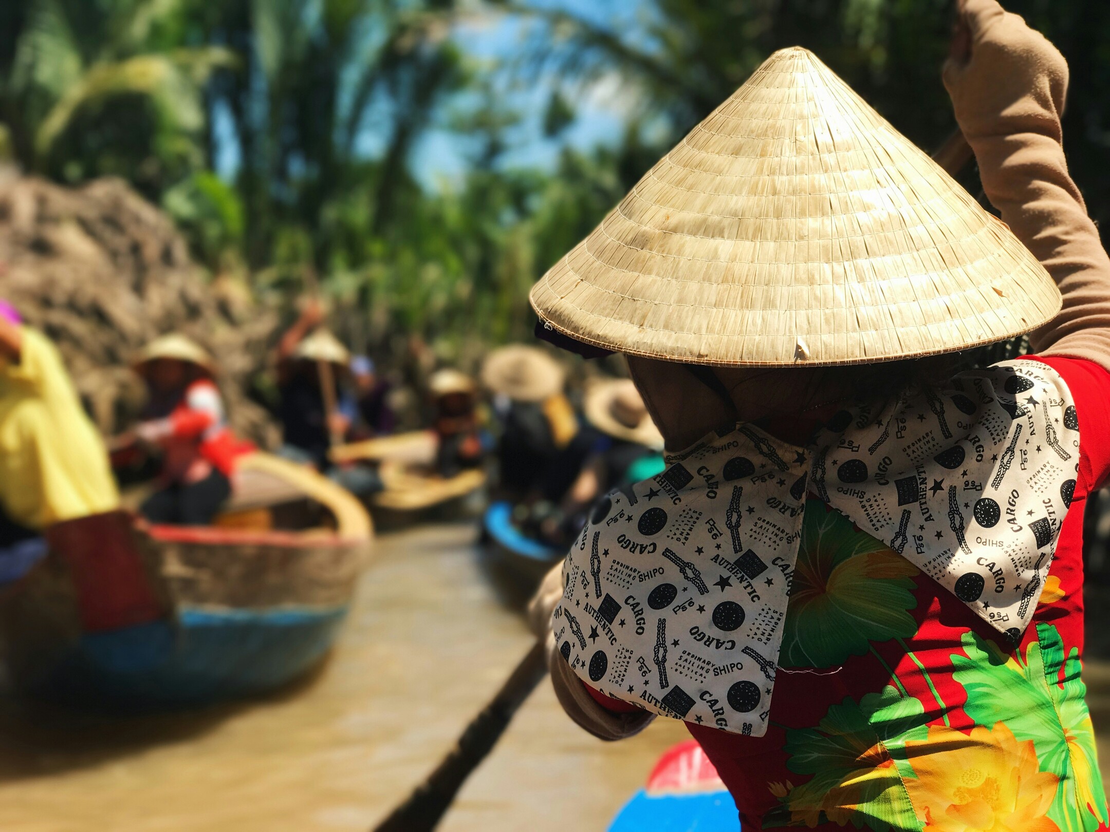 Mekong Delta boaters in conical hats feature