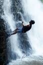 Rappelling down a waterfall