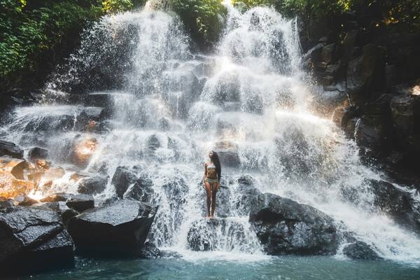 Ubud, Bali, woman + waterfall - featured,