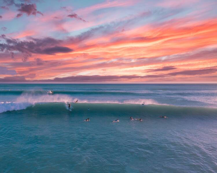 Surfers at sunset