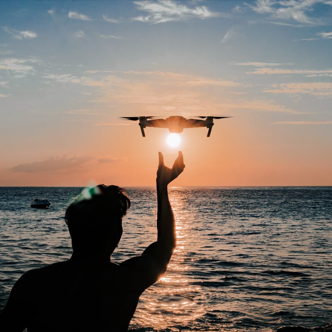 Man with drone at sunset in Bali