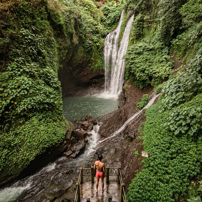 Man looking at waterfall in Bali