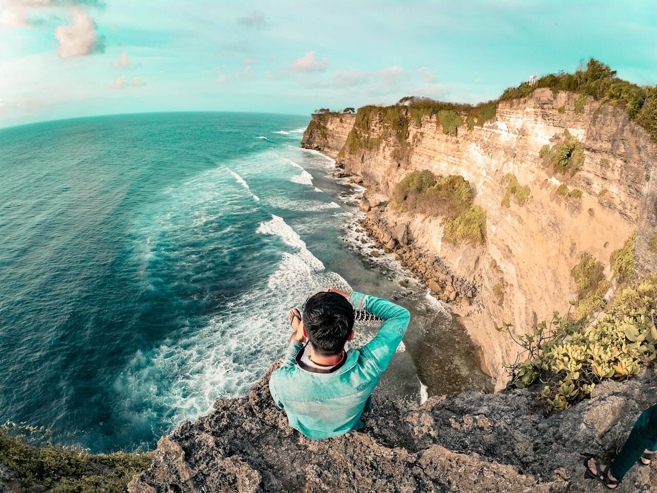 Man taking photo on cliff in Bali